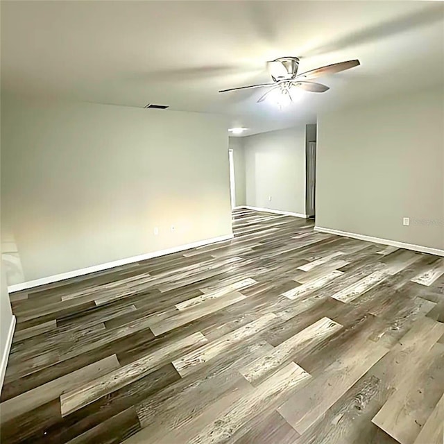 empty room with ceiling fan and wood-type flooring