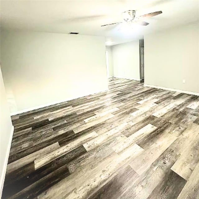 empty room with hardwood / wood-style flooring and ceiling fan