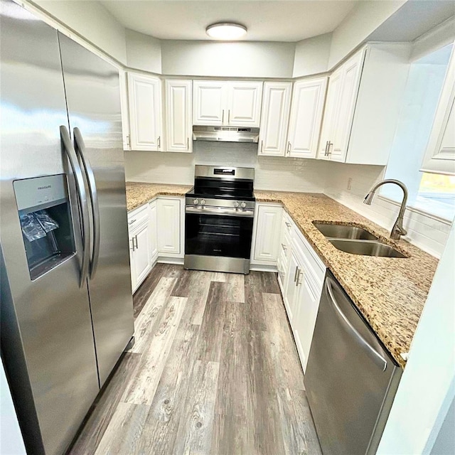 kitchen featuring white cabinetry, sink, stainless steel appliances, and light wood-type flooring