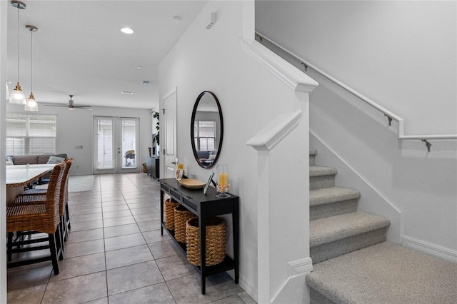 stairway featuring tile patterned flooring, french doors, and ceiling fan