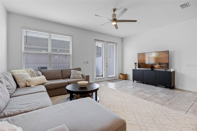 tiled living room featuring ceiling fan