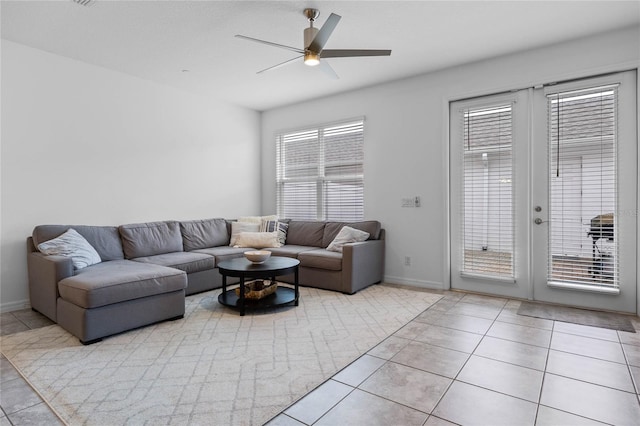 tiled living room featuring ceiling fan and french doors