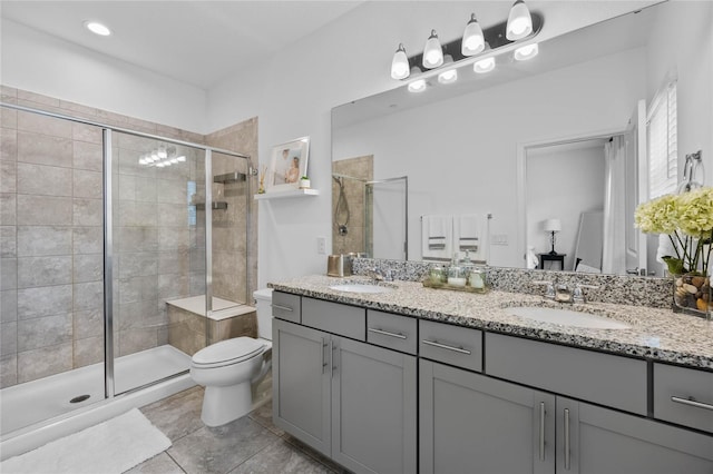 bathroom featuring vanity, toilet, an enclosed shower, and tile patterned flooring