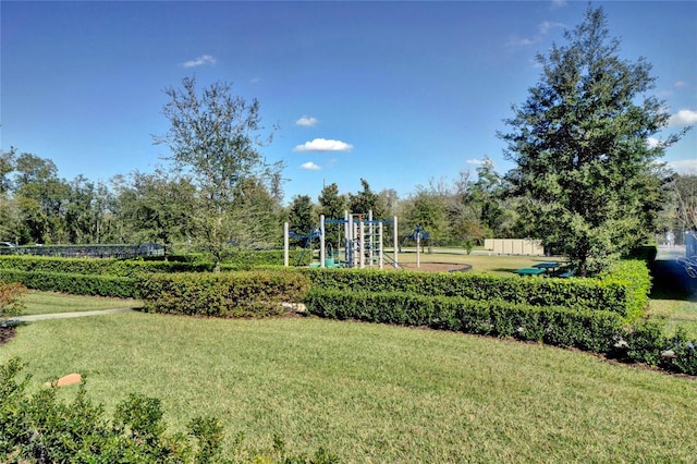 view of home's community featuring a playground and a lawn