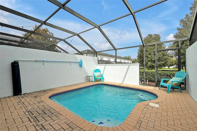 view of swimming pool with a lanai and a patio area