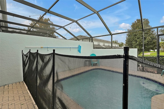 view of swimming pool featuring a lanai