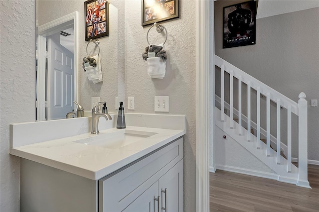 bathroom with vanity and wood-type flooring