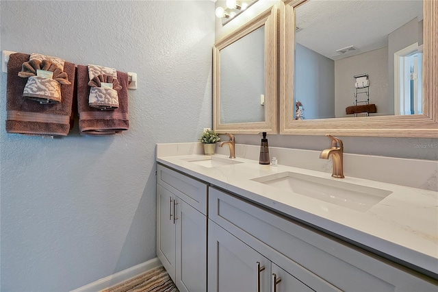 bathroom featuring vanity and a textured ceiling