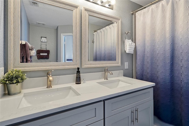 bathroom with vanity and a textured ceiling