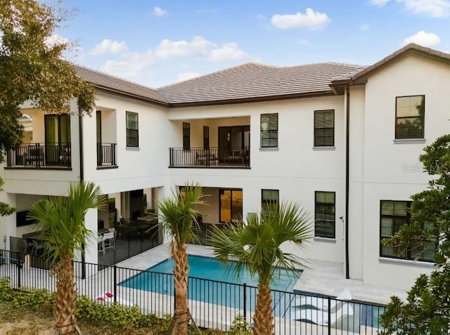 back of house featuring a fenced in pool and a patio area