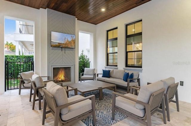 view of patio / terrace with an outdoor living space with a fireplace