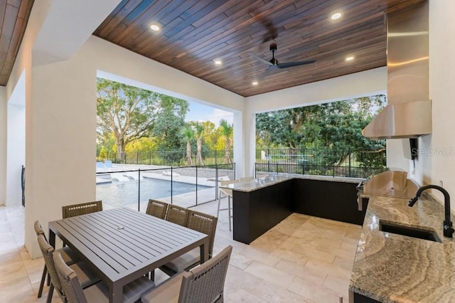 view of patio / terrace featuring sink, a grill, ceiling fan, and exterior kitchen