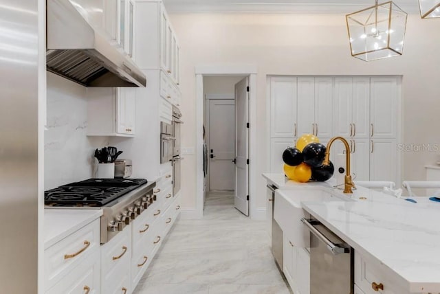 kitchen featuring appliances with stainless steel finishes, white cabinetry, sink, hanging light fixtures, and light stone counters