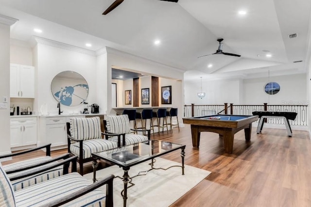 playroom featuring lofted ceiling, crown molding, light hardwood / wood-style flooring, and ceiling fan