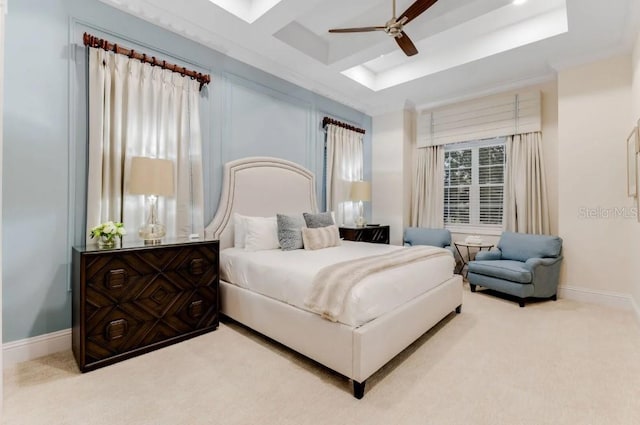 carpeted bedroom featuring coffered ceiling, a skylight, and ceiling fan