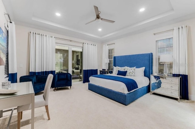 bedroom featuring a tray ceiling, ceiling fan, and carpet flooring