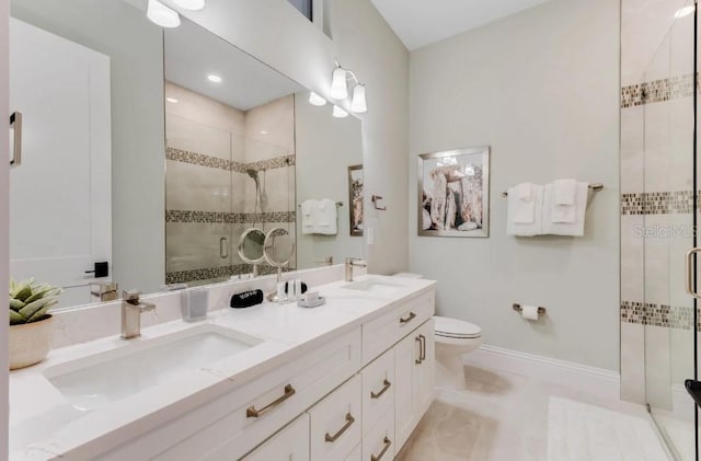 bathroom with vanity, toilet, and an enclosed shower