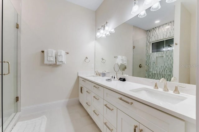 bathroom with walk in shower, vanity, and tile patterned flooring