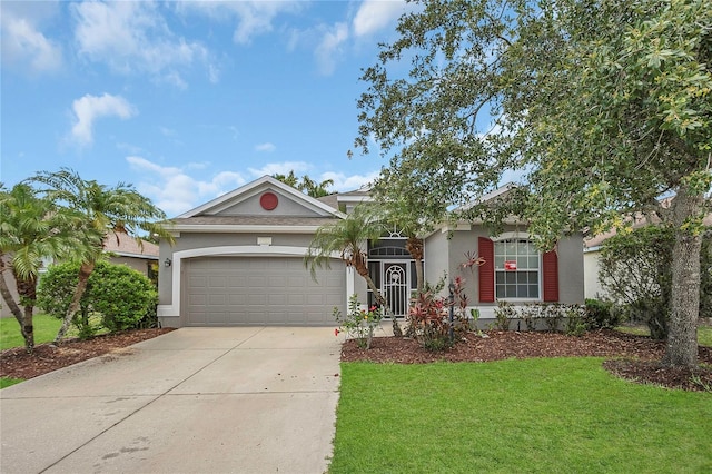 11530 57th Street Cir E, Parrish, FL 34219 - view of front of property with an attached garage, concrete driveway, stucco siding, and a front yard