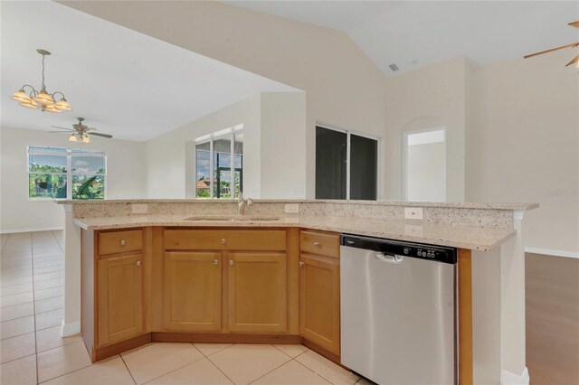 11530 57th Street Cir E, Parrish, FL 34219 - kitchen with stainless steel dishwasher, a sink, light stone counters, open floor plan, and lofted ceiling