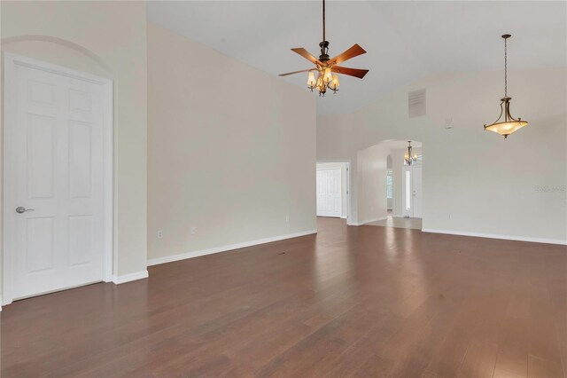 11530 57th Street Cir E, Parrish, FL 34219 - unfurnished living room featuring ceiling fan, dark wood-type flooring, a chandelier, baseboards, and high vaulted ceiling