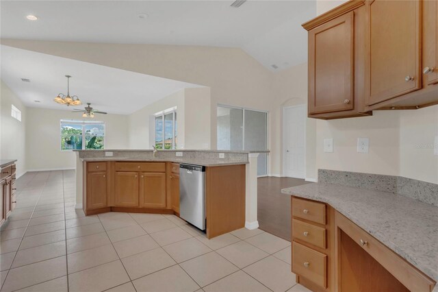 11530 57th Street Cir E, Parrish, FL 34219 - kitchen with stainless steel dishwasher, vaulted ceiling, light tile patterned floors, light stone countertops, and a sink