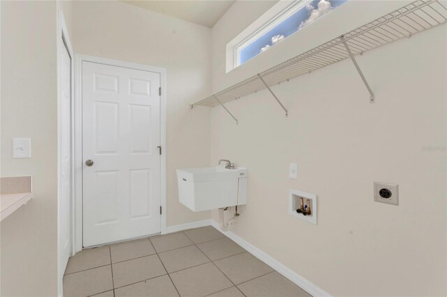 11530 57th Street Cir E, Parrish, FL 34219 - laundry room with electric dryer hookup, hookup for a washing machine, light tile patterned flooring, and baseboards