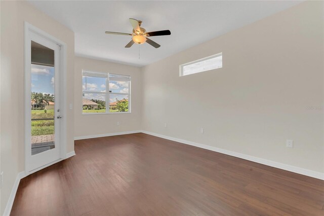 11530 57th Street Cir E, Parrish, FL 34219 - empty room with dark wood-type flooring, baseboards, and a ceiling fan
