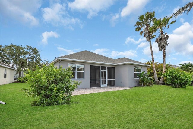 11530 57th Street Cir E, Parrish, FL 34219 - rear view of property featuring stucco siding, a patio, a lawn, and a sunroom