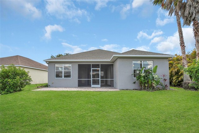 11530 57th Street Cir E, Parrish, FL 34219 - rear view of property featuring stucco siding, a lawn, and a sunroom
