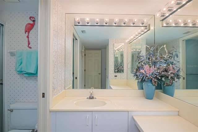 bathroom featuring vanity and toilet