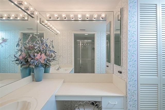 bathroom featuring vanity and a shower with shower door