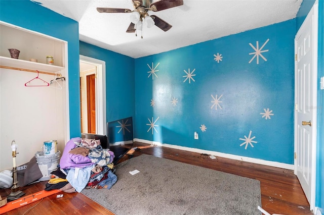 unfurnished bedroom featuring hardwood / wood-style flooring and ceiling fan