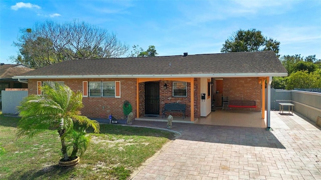 single story home featuring a carport and a front yard