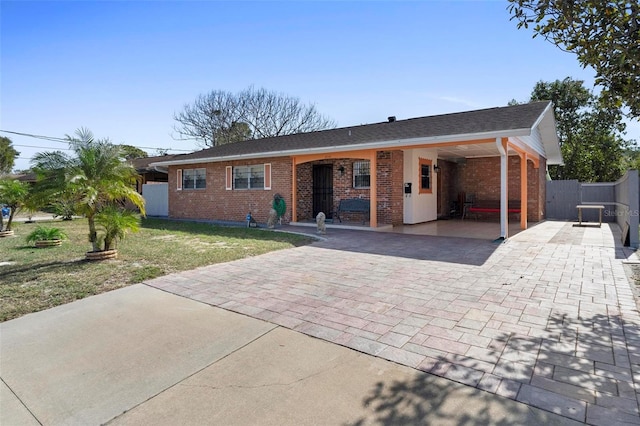 ranch-style home with a carport and a front lawn