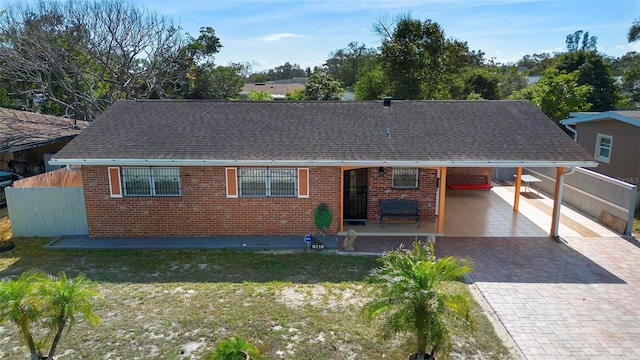 single story home with a carport and a front lawn