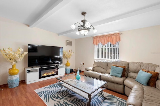 living room with an inviting chandelier, light hardwood / wood-style flooring, a wall unit AC, and beamed ceiling