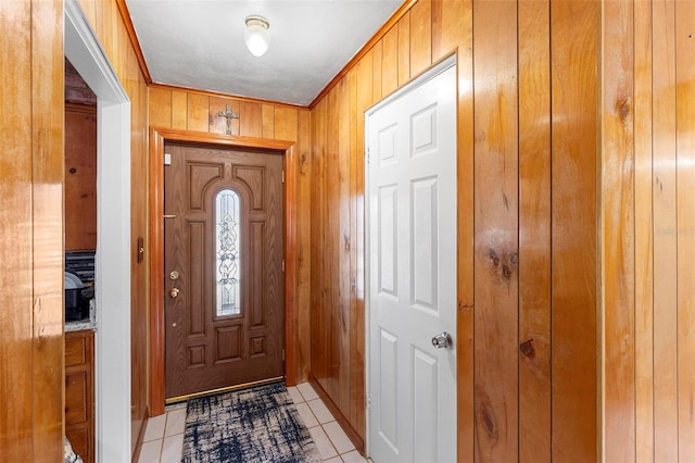 entryway featuring wood walls and light tile patterned flooring