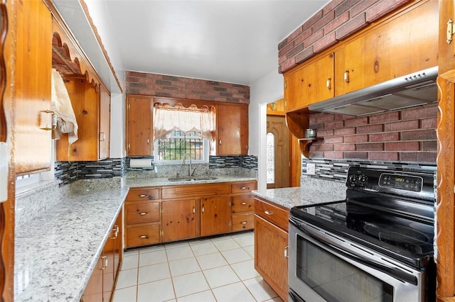 kitchen featuring stainless steel electric range oven, sink, light stone counters, and extractor fan