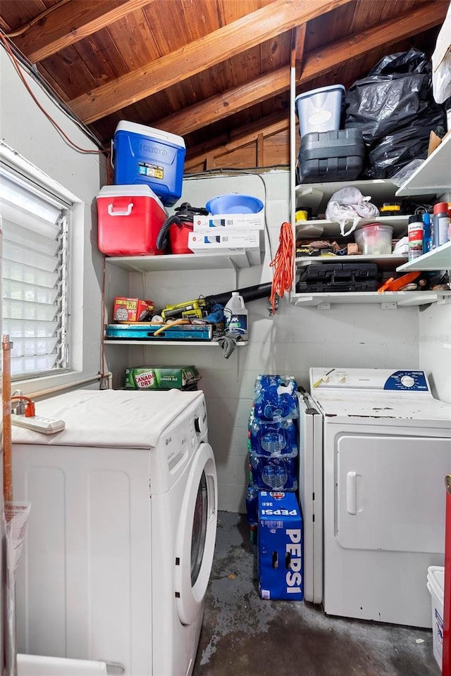 clothes washing area with washer and clothes dryer