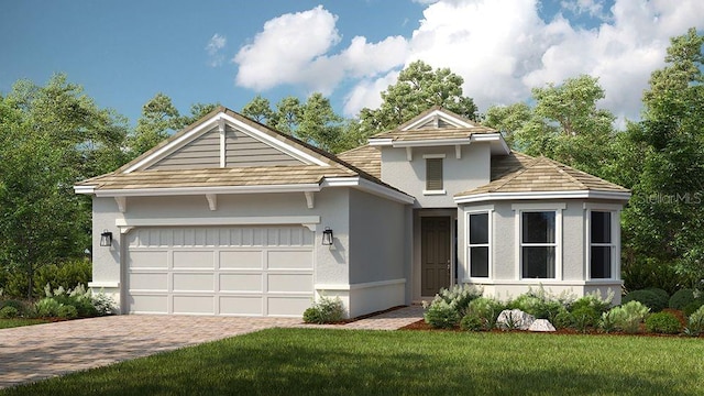 view of front of property with a garage and a front lawn