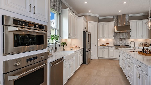 kitchen with decorative light fixtures, white cabinetry, backsplash, stainless steel appliances, and crown molding