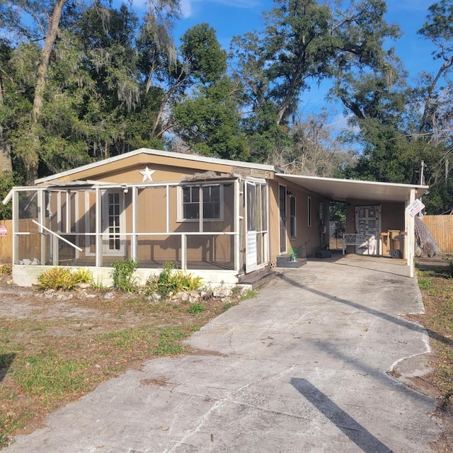 manufactured / mobile home with a carport and a sunroom