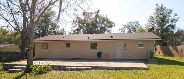 rear view of house featuring a yard, a patio area, and central air condition unit