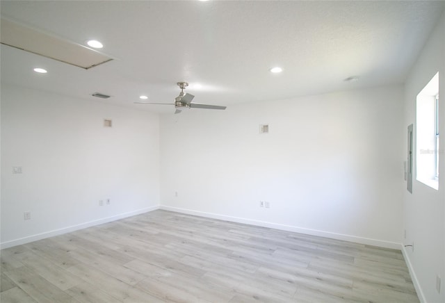 empty room with ceiling fan and light wood-type flooring