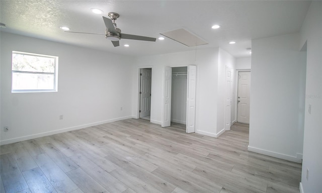 unfurnished bedroom with ceiling fan, light hardwood / wood-style flooring, and a textured ceiling