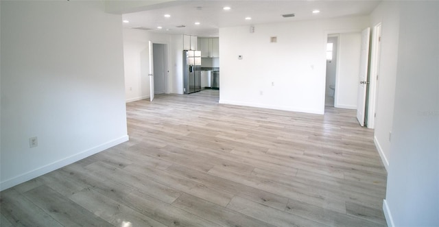 unfurnished room with light wood-type flooring