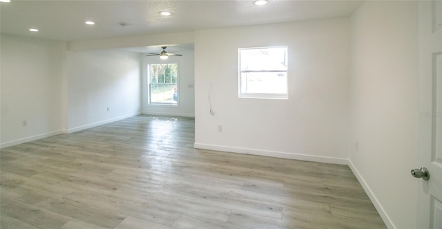 unfurnished room with ceiling fan and light hardwood / wood-style floors