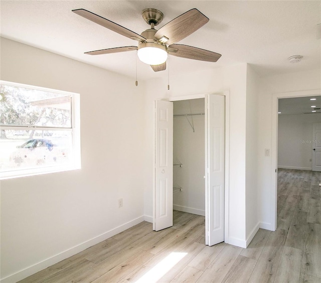 unfurnished bedroom featuring a closet, ceiling fan, and light wood-type flooring