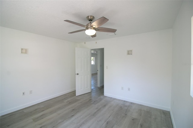 spare room featuring ceiling fan, a textured ceiling, and light hardwood / wood-style floors